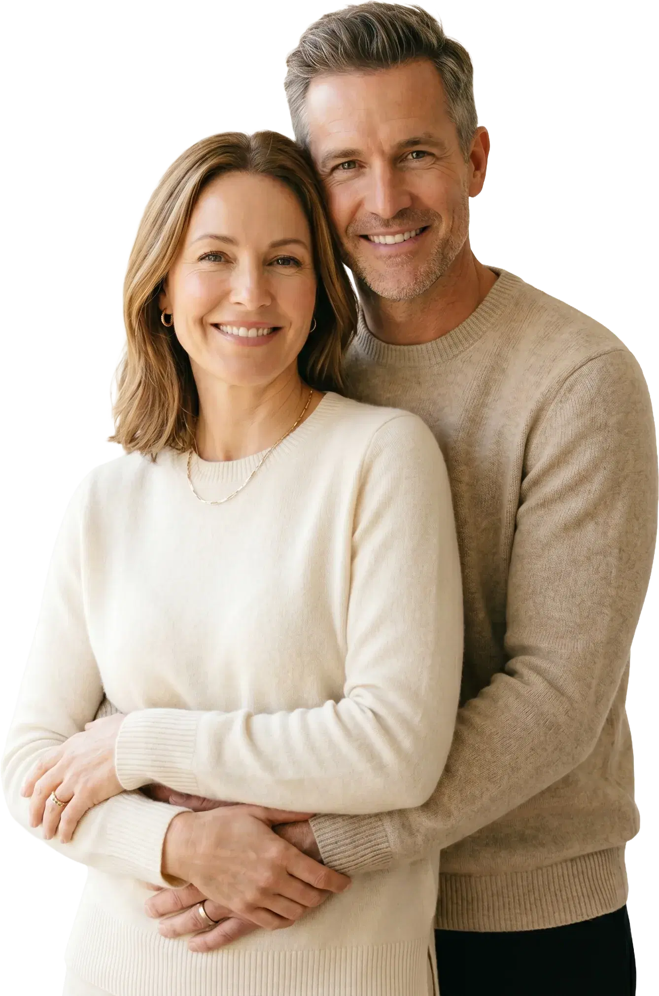 A smiling couple in cream sweaters