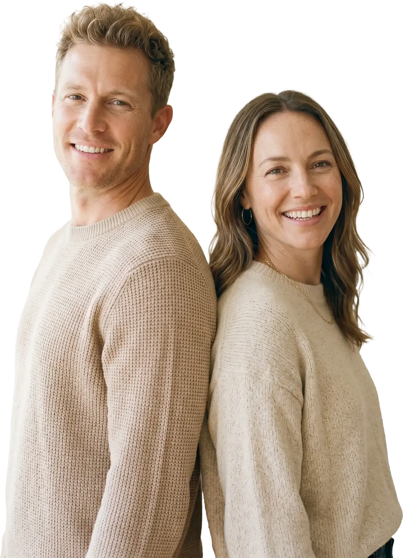 A smiling man and woman standing back to back