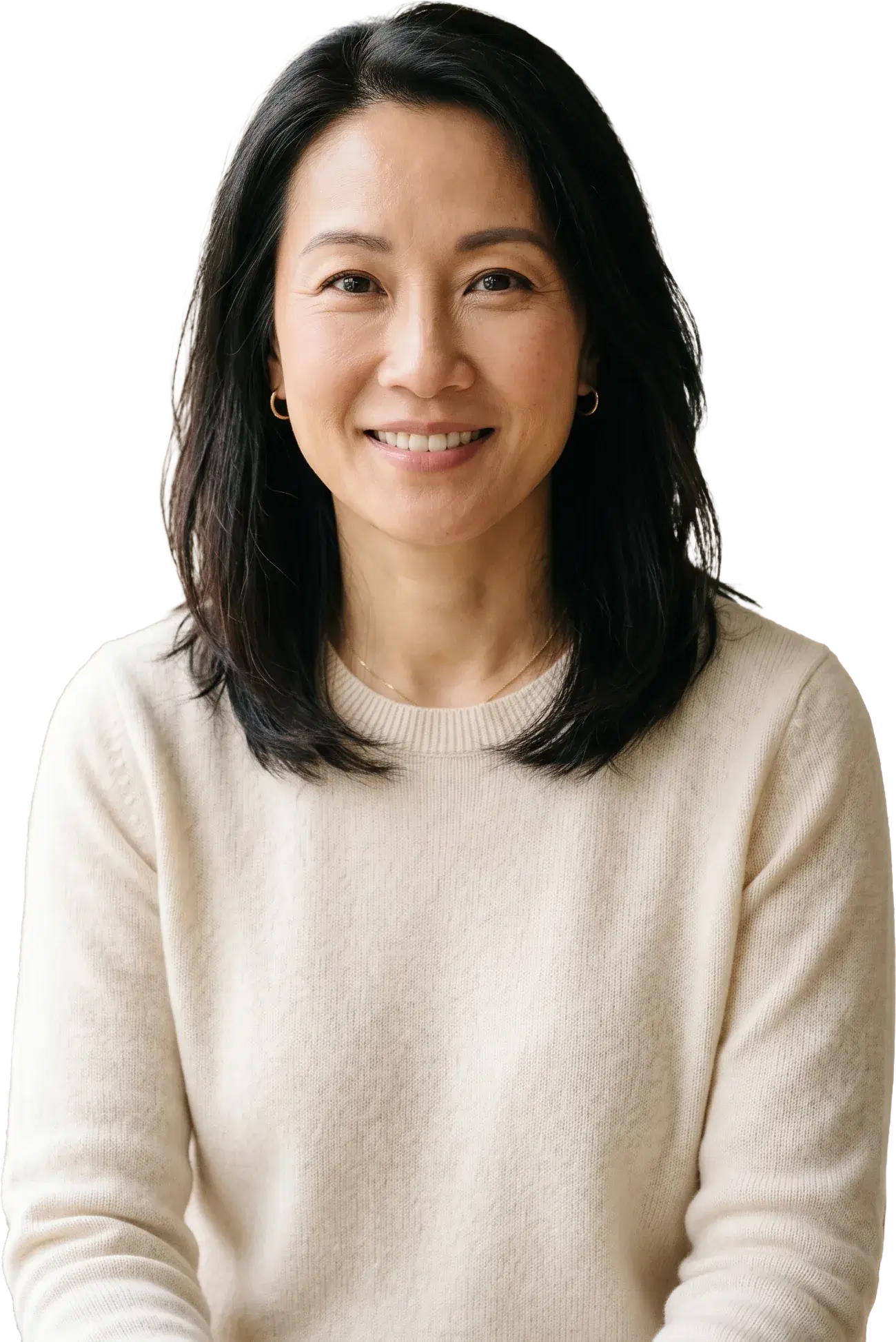 A smiling woman with dark hair in a cream sweater