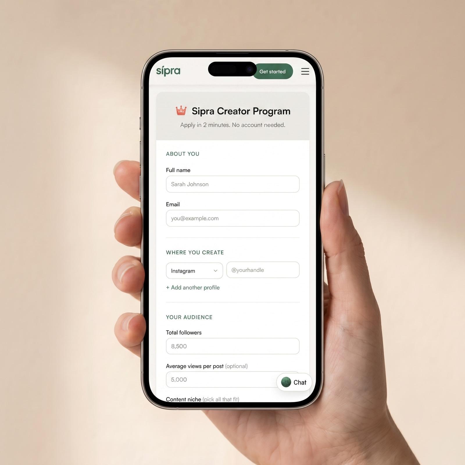 A creator holding a phone open to the Sipra Creator Program application